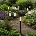 black landscape spike light installed in boarders along a pathway