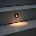 black outdoor stair step light mounted into concrete steps outside