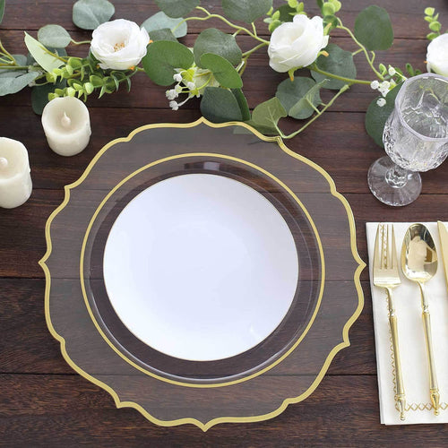 Elegant gold-trimmed clear charger plate with white center on rustic wood table.
