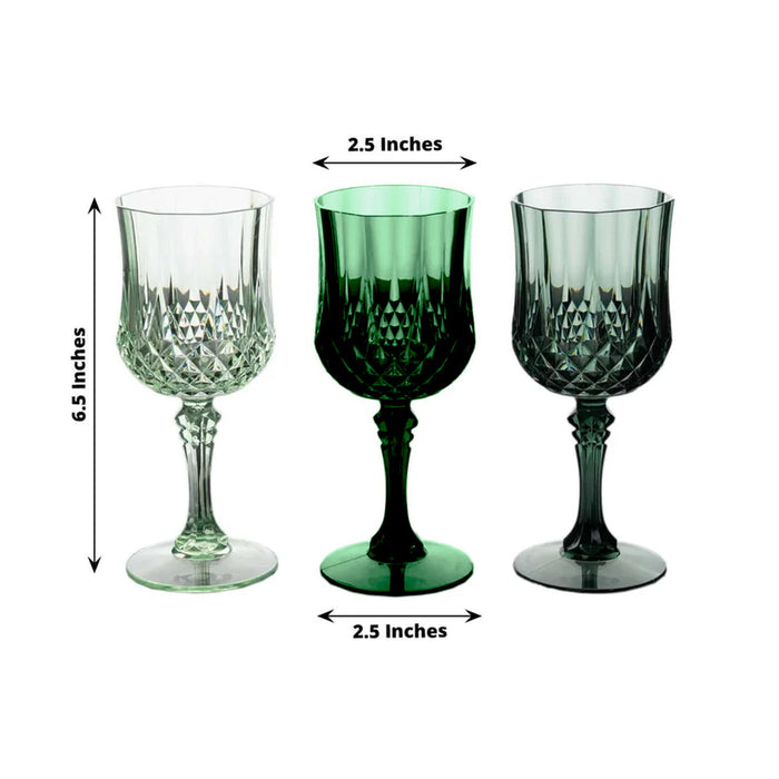 Set of three decorative crystal glasses in clear, green, and dark green.