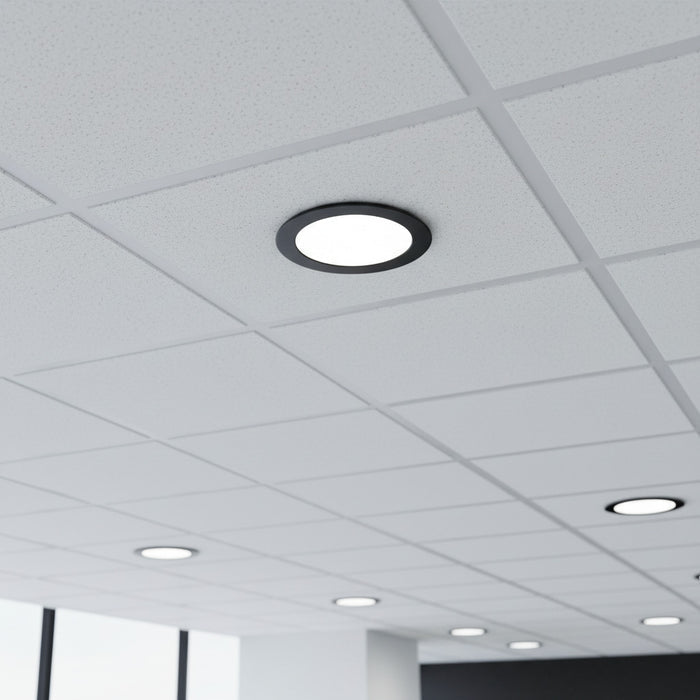 black low profile downlight installed into a suspended ceiling in an office