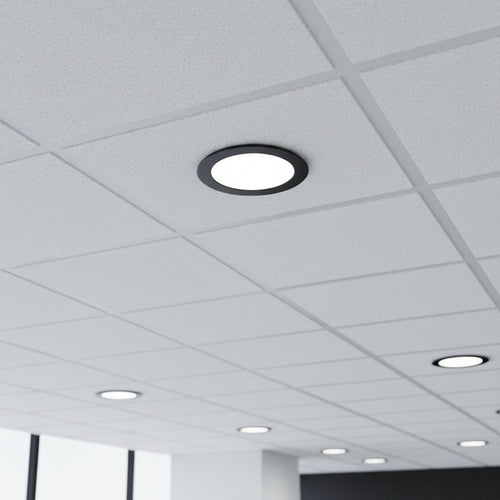 black low profile downlight installed into a suspended ceiling in an office