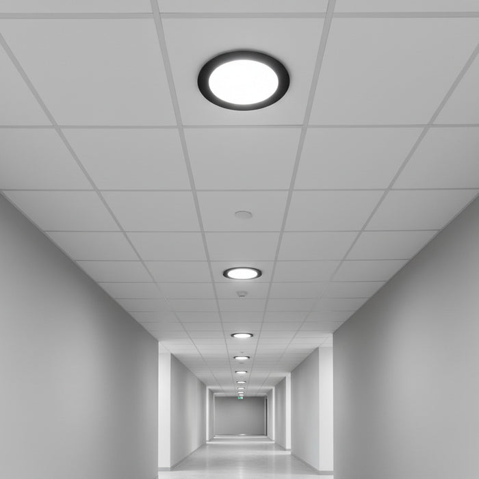 black low profile downlight installed into the ceiling of an office hallway