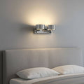 Polished chrome over bed reading light installed over a bed in a clean modern bedroom
