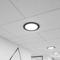 black slimline ceiling downlight installed in a supended ceiling