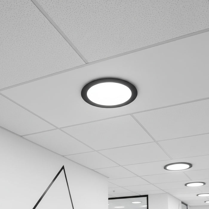 black slimline ceiling downlight installed in a supended ceiling