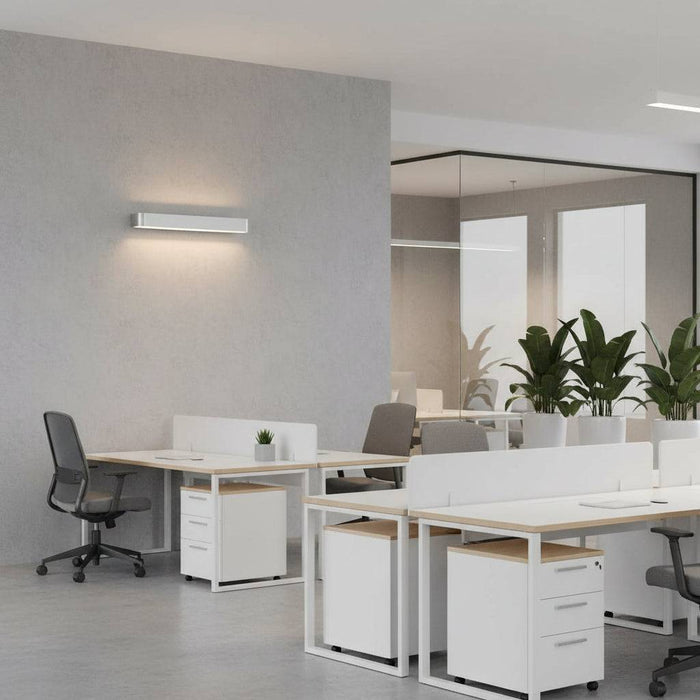 Silver up and down dimmable internal wall light on the wall of  a modern office suite