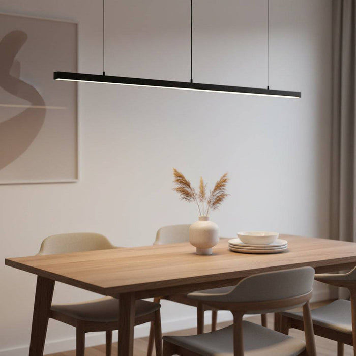 Black linear pendant light fixture above a table in a modern home