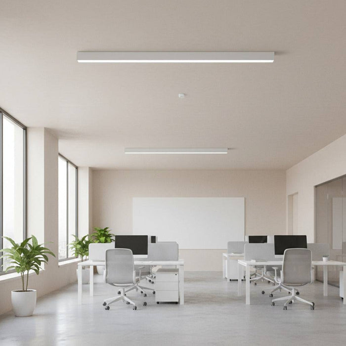 white linear surface mounted light fitted on the ceiling in an office