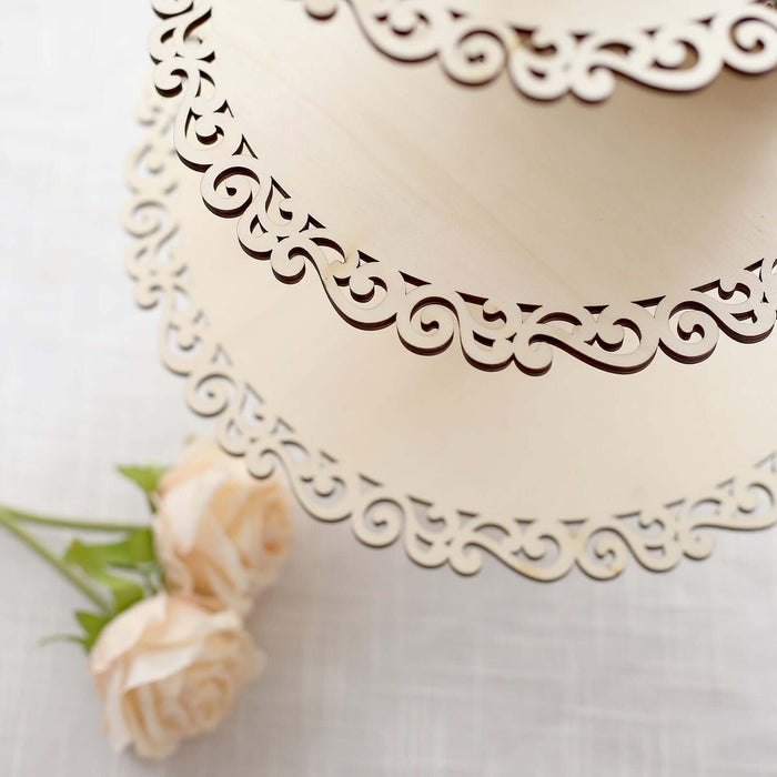 Decorative laser-cut wooden cake stand with elegant scroll design.