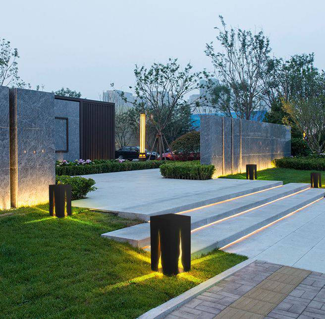 Black contemporary square path bollard light on a stepped garden entrance