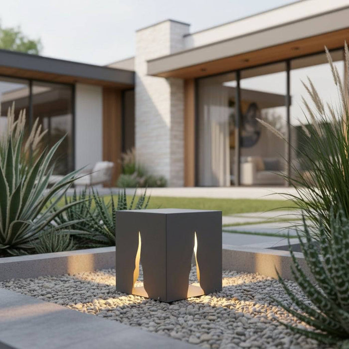 Grey contemporary bollard light set in the garden of a modern home