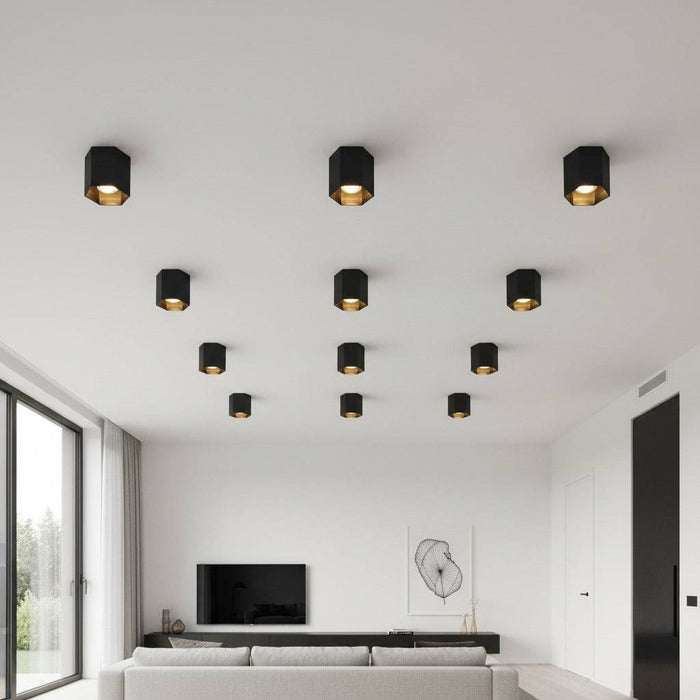 black flush ceiling lamp fixture mounted in a group on a white ceiling in a home