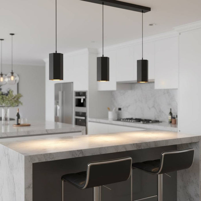 Black pendant light fitting above a breakfast bar in a modern home