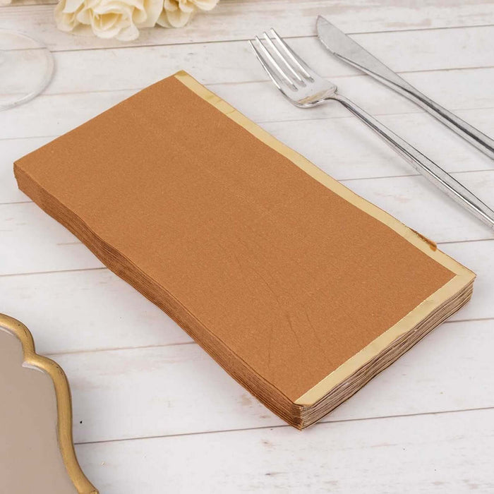 Brown paper napkins stacked on a wooden table.