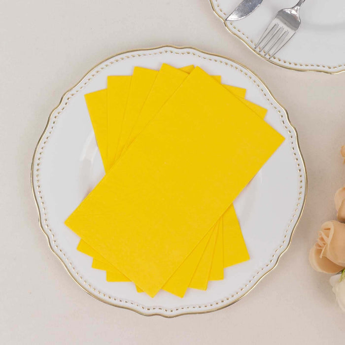 Yellow paper napkins stacked on an elegant plate.