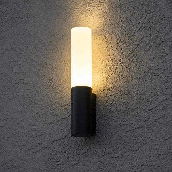 black lantern outdoor light mounted on an exterior textured wall