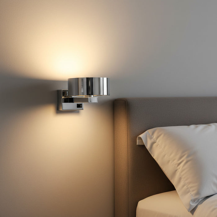 chrome bedside wall reading light mounted next to a bed