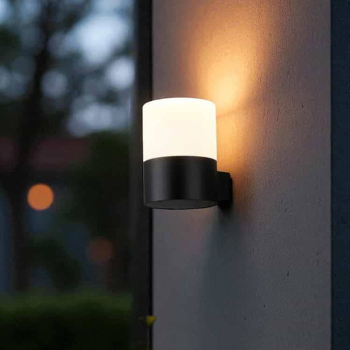 black outside wall mounted light fitted on a textured outside wall