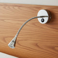 polished chrome flexible reading lamp fitted to a wooden bed headboard