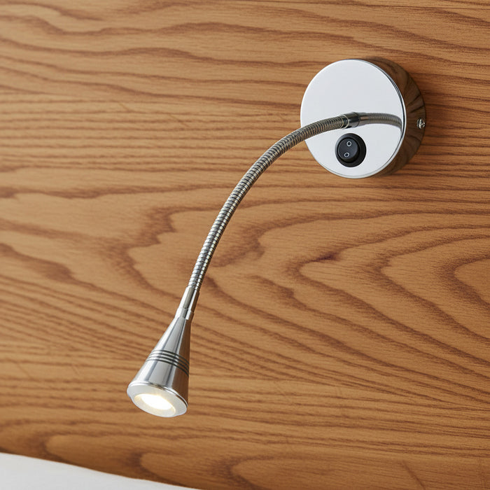 polished chrome flexible reading lamp mounted on a wooden headboard