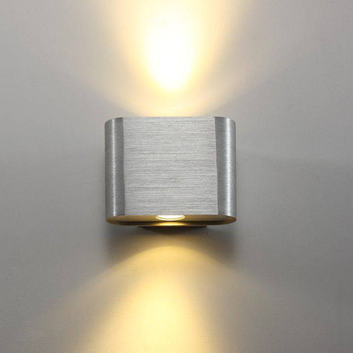 Silver up down indoor wall sconce on a grey background