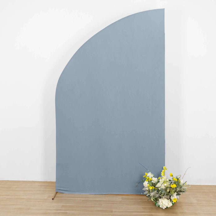 Blue fabric backdrop with floral arrangement in front.