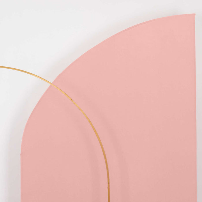Pink curved backdrop with a gold arch, studio-style isolation shot.