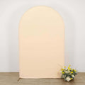 Peach-colored backdrop with floral arrangement at the base.