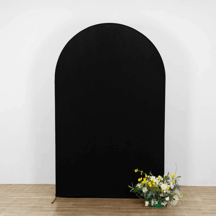 Black arch backdrop with flowers at the base.