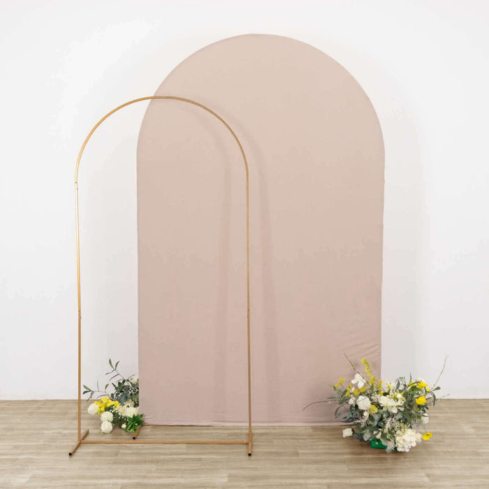 Gold arch stand with pastel backdrop and floral arrangements