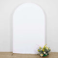 Arch-shaped backdrop with floral arrangement in front