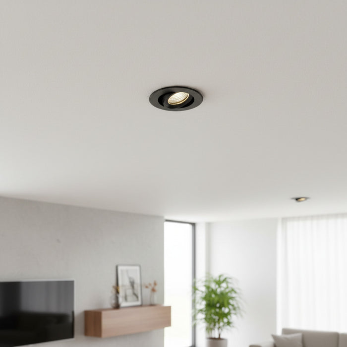 black IP65 LED downlight fitting mounted in the ceiling of a living room
