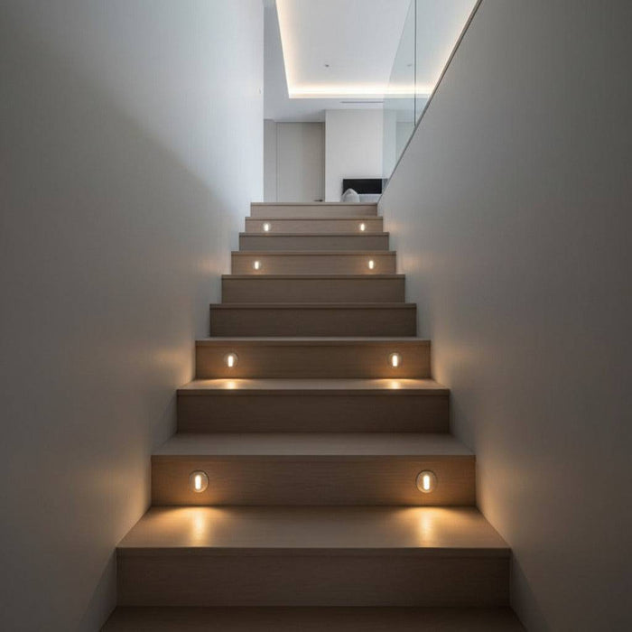 silver recessed step light shown installed into wooden stair risers