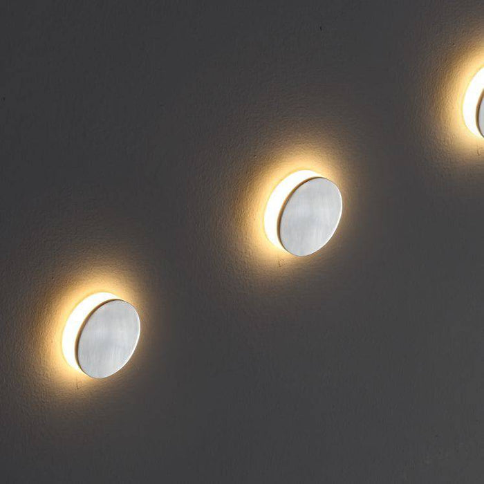silver staircase tread lighting installed on a grey wall