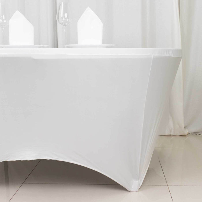 White table with elegant draping and glassware set for dining
