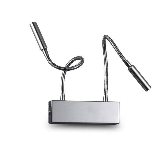 chrome over bed reading light mounted on a white wall